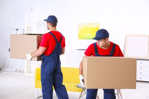 Furniture collection team handling bulky items in a Balham home