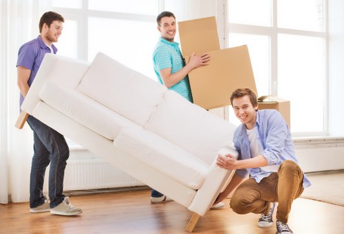 Furniture and boxes being moved from a Balham home with stair access