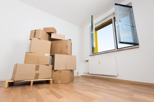 Office movers handling furniture in a Balham property