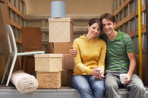 Driver and helper handling household items for transport