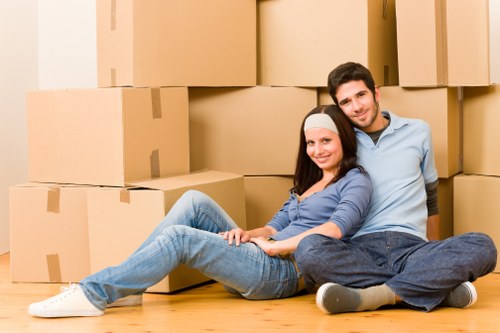 Movers handling furniture in a Balham flat with stairs